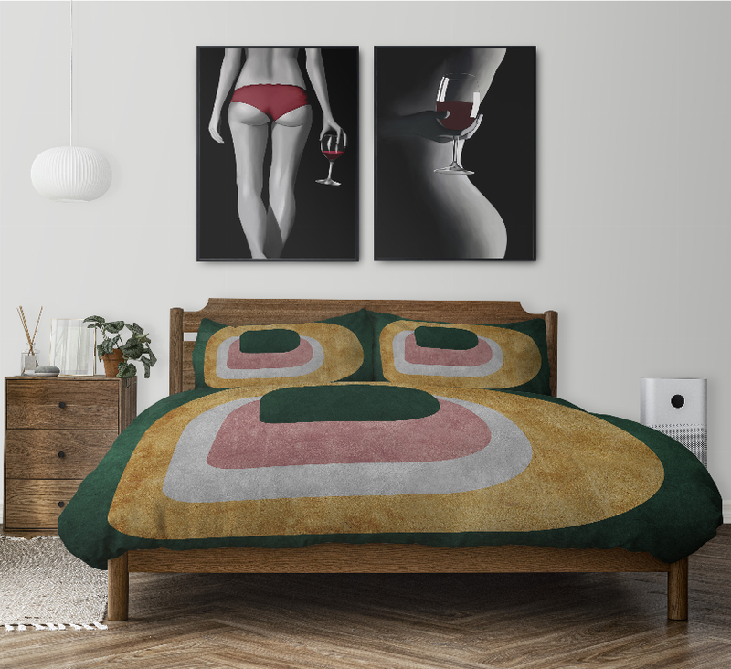 Abstract comforter set with matching pillows in green, tan, and pink rounded shapes