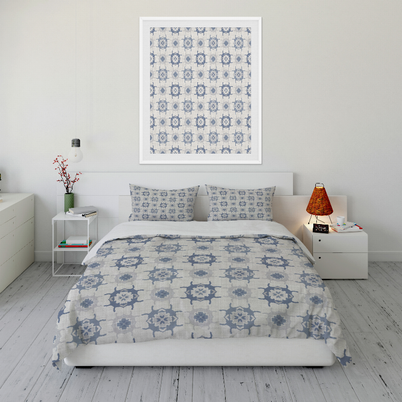 Blue geometric comforter set with two pillow shams on a bed
