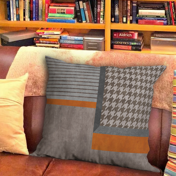 Patchwork throw pillow cover with gray stripes, houndstooth panel, and orange bands