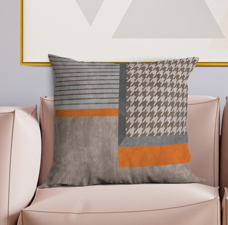 Patchwork square pillow with gray striped and houndstooth squares, orange accent bands