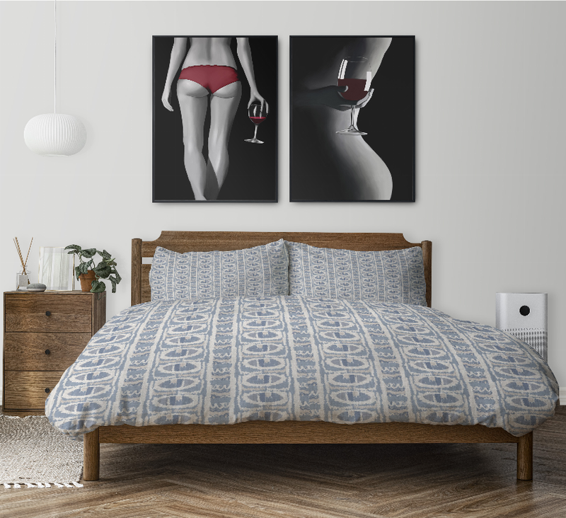 Blue patterned duvet cover set on wooden bed frame, with two matching shams