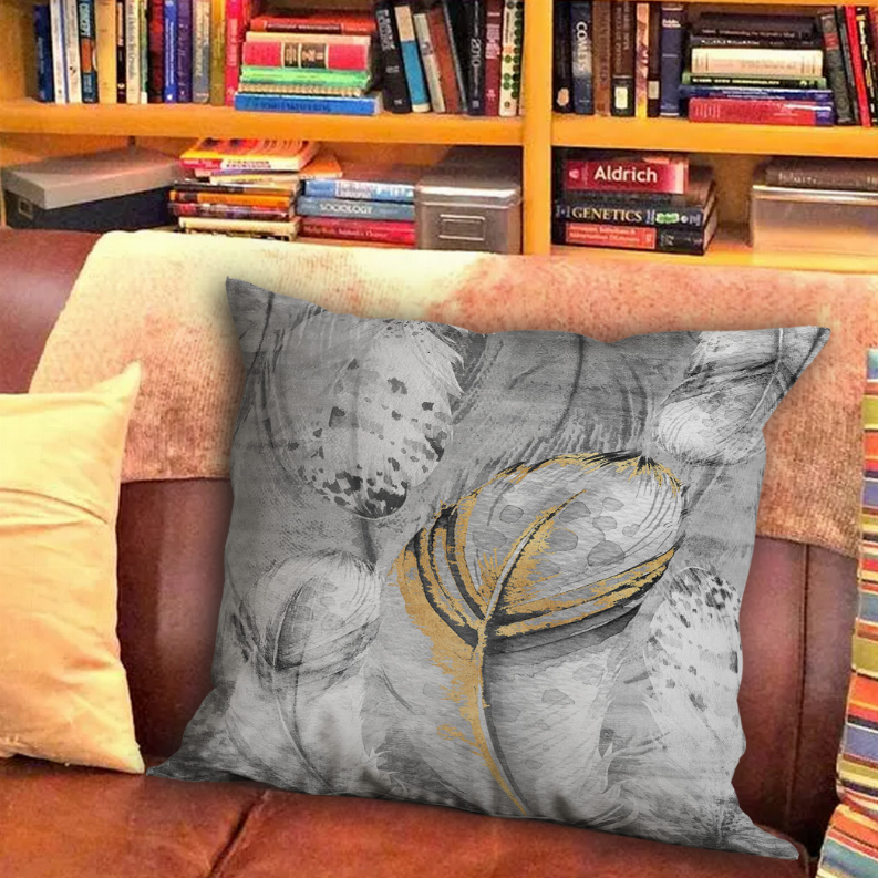 Gray throw pillow with abstract feather graphic and gold-yellow outline