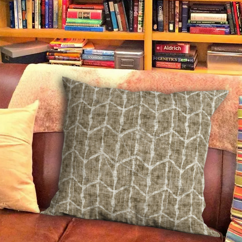 Square throw pillow with gray geometric lines on beige textured fabric