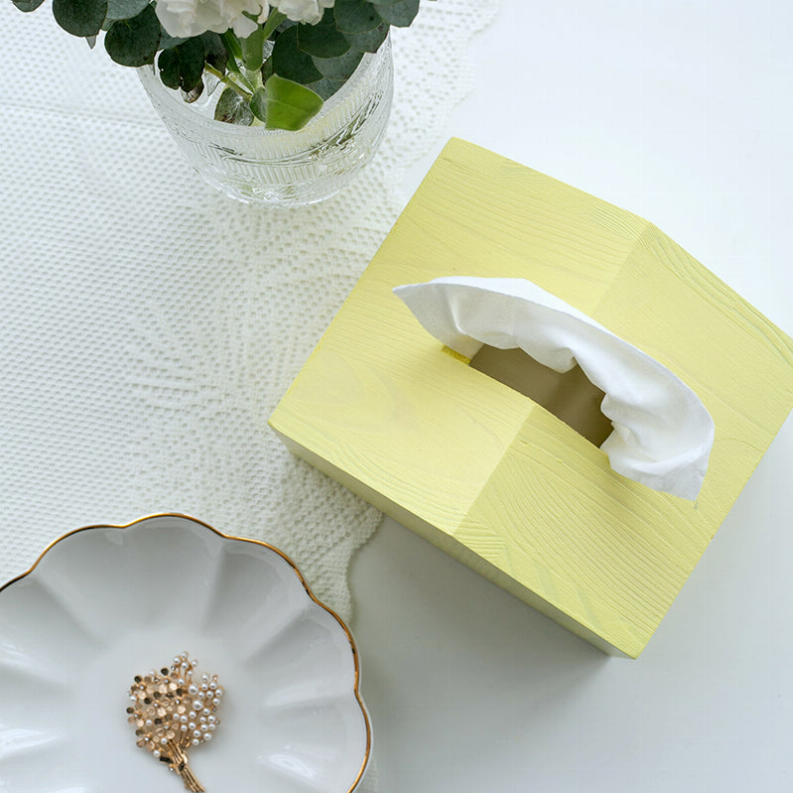 Yellow fabric tissue box cover with rectangular opening on top