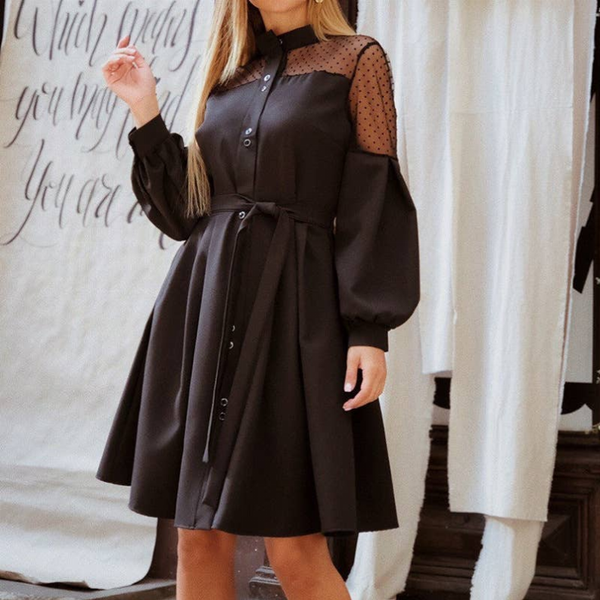 Black long-sleeve button front dress with sheer dotted sleeves and tied waist belt