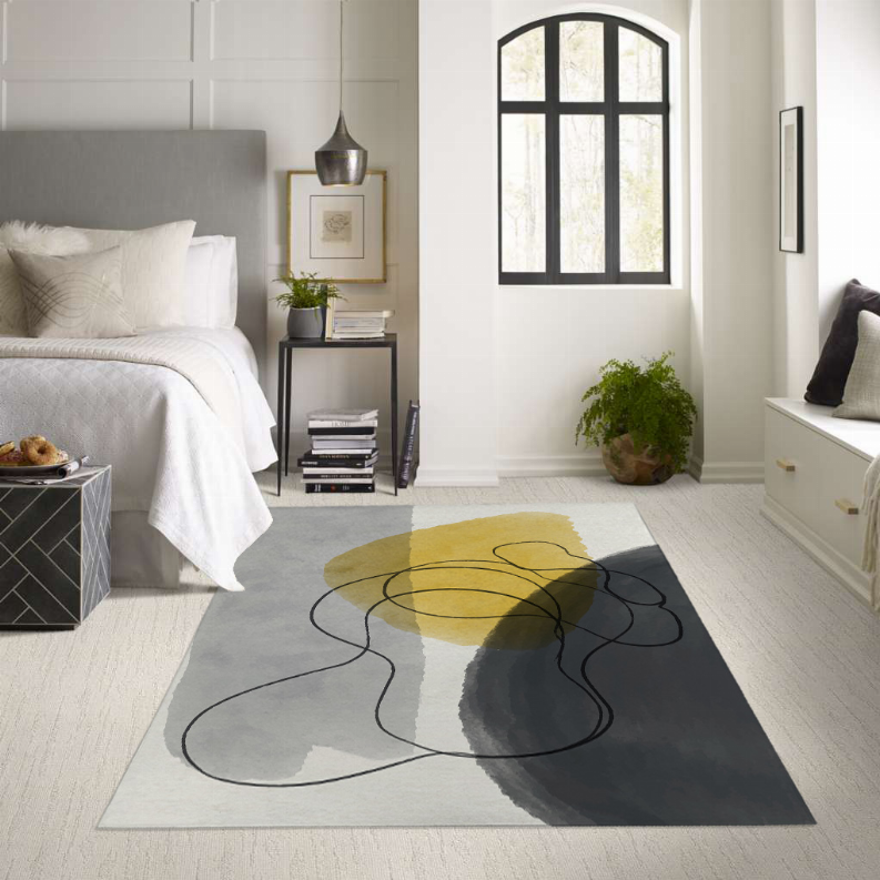 Low pile abstract area rug in gray with yellow oval and black looping line pattern