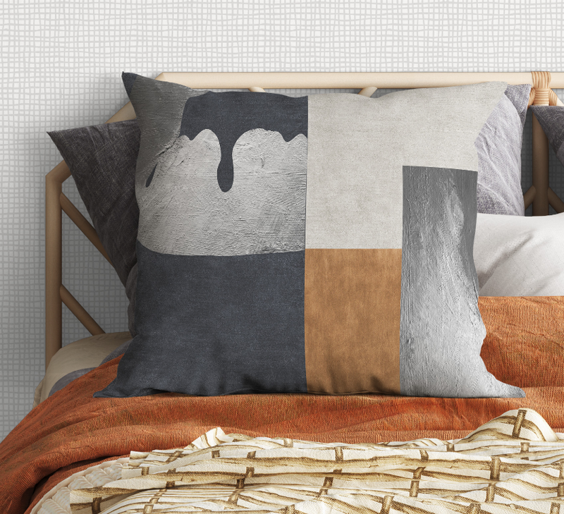 Geometric patchwork throw pillow with black, gray, beige, and light gray block pattern