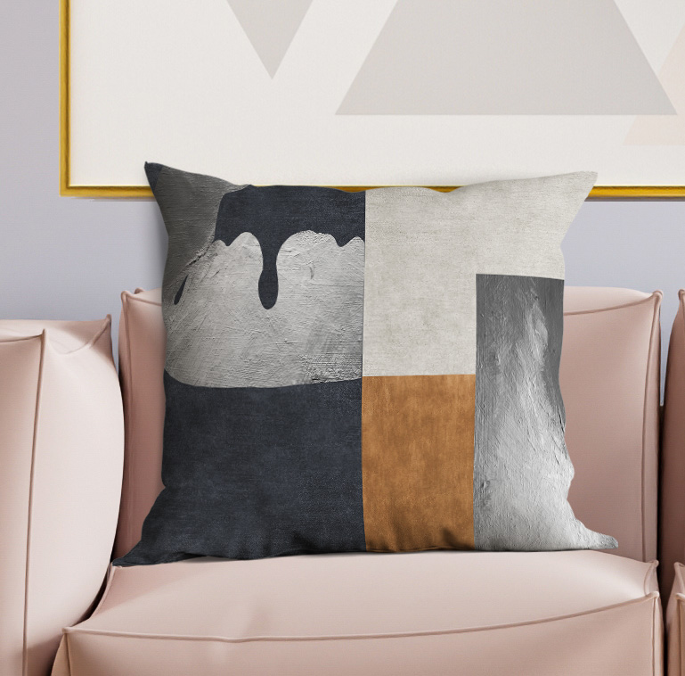 Geometric patchwork pillow featuring black, gray, beige, and light gray rectangular panels