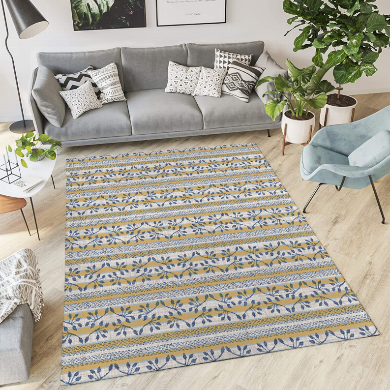 Low pile area rug with blue, white, and tan geometric stripe motif