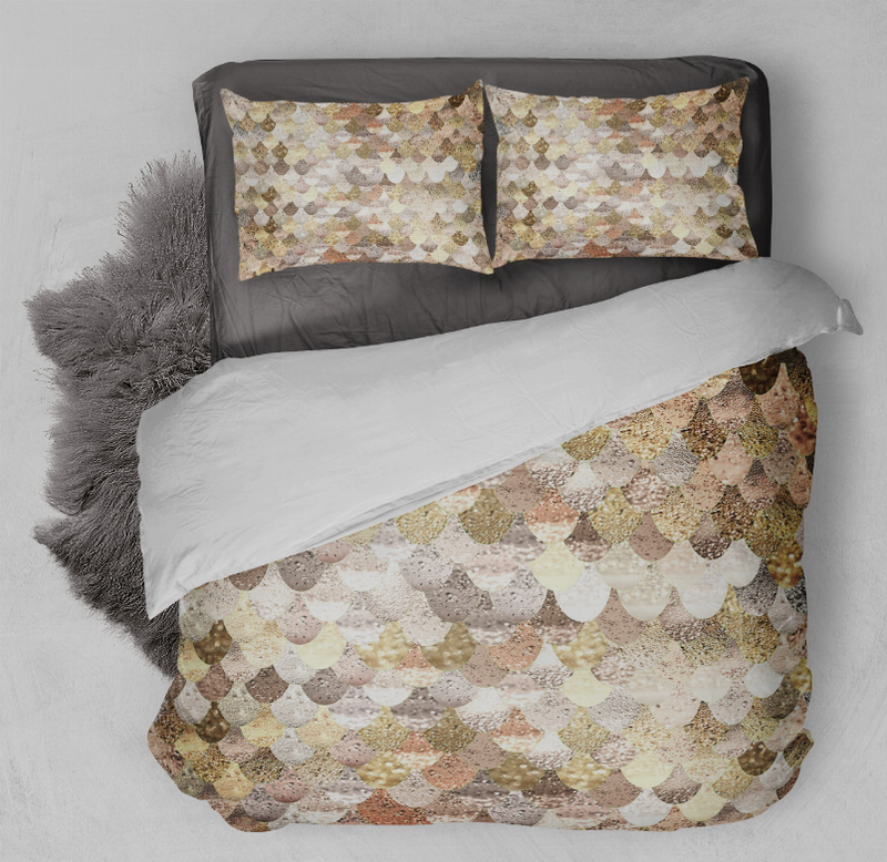 Comforter set detail: gold and beige scallop-pattern comforter with two matching pillows