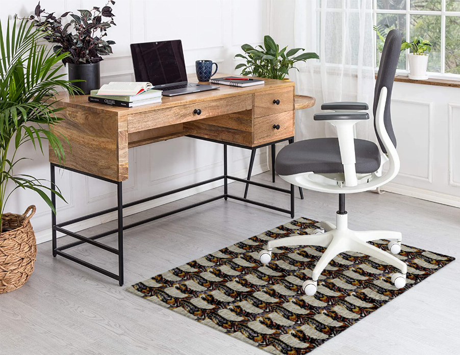 Low pile multi-color patterned carpet laid on floor beside desk chair