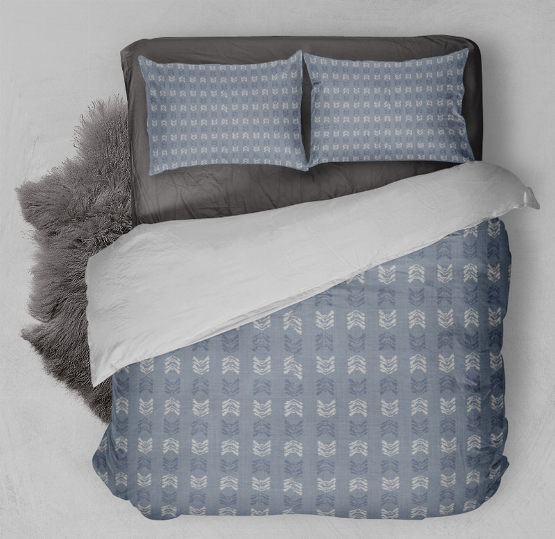 Blue duvet cover set with repeating arrow pattern, close-up on duvet and pillow covers