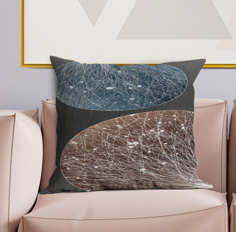 Throw pillow on sofa with teal-blue and brown abstract white line swirls