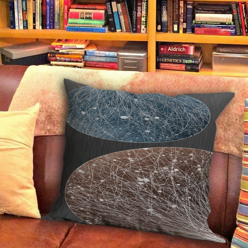 Throw pillow on armchair with teal-blue and brown abstract white line pattern