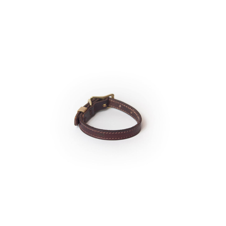 Burgundy full-grain leather dog collar with brass buckle hardware, side view