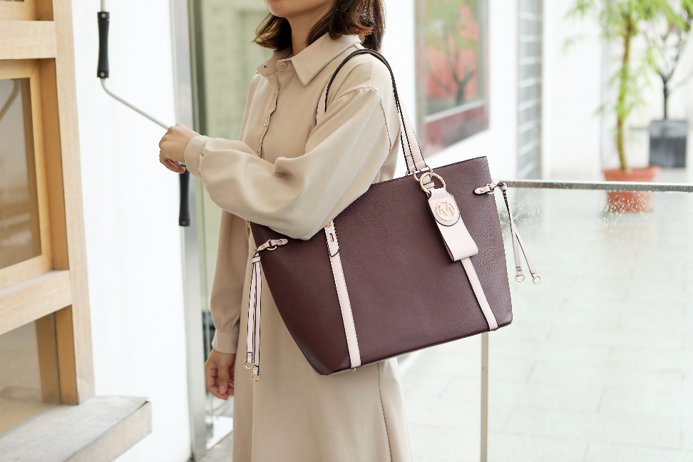Maroon tote bag with light trim, detachable wallet and key-ring, top handles and zips
