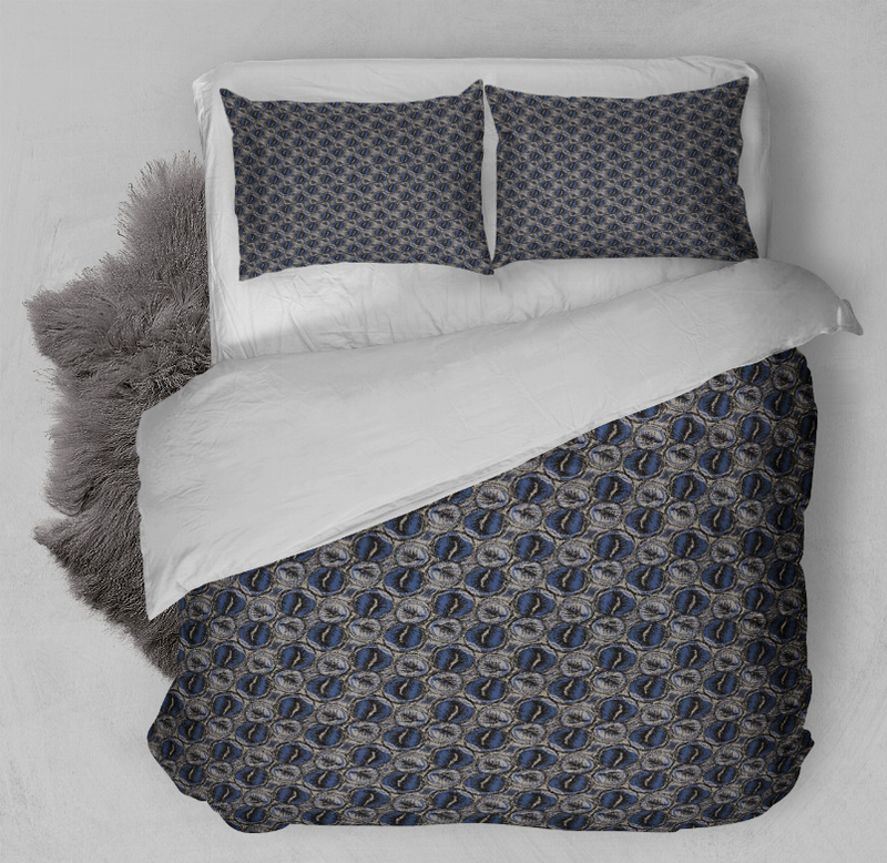 Blue patterned duvet cover set with two pillow shams, shown from side angle