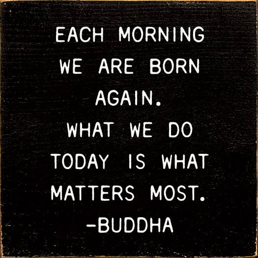 Black quote wall art with white inspirational text, ending with “-BUDDHA”.