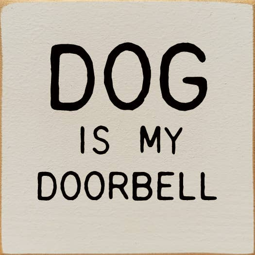 Square decorative sign with bold "DOG IS MY DOORBELL" text