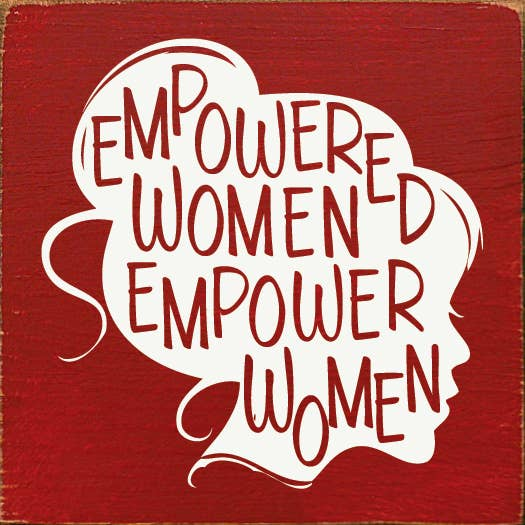 Red wooden wall sign with white “Empowered Women” lettering