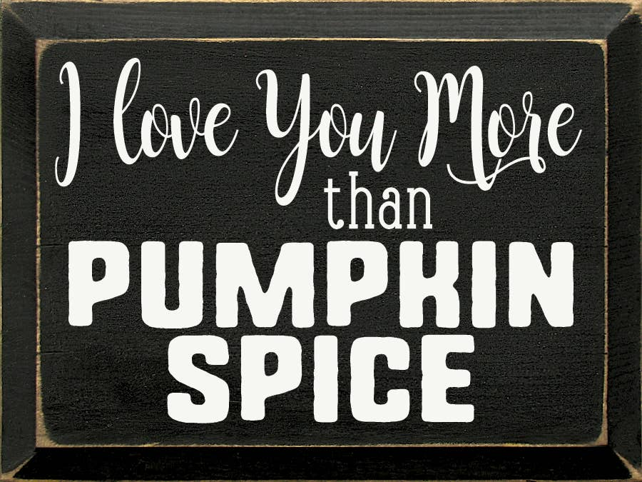 Black rectangular sign with white quote text: I love you more than pumpkin spice