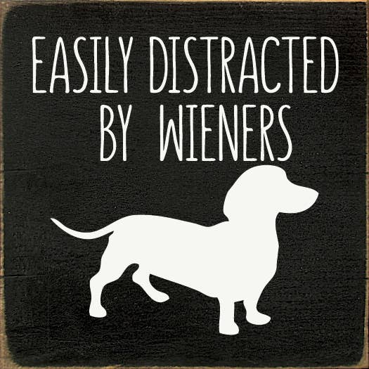 Black sign with white 'Easily Distracted by Wieners' text and dog silhouette