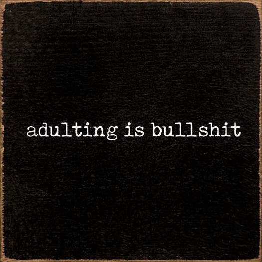 Black fabric square with "adulting is bullshit" printed text