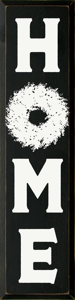 Home wreath wall decor with dark background, white H, M, E letters, and circular wreath