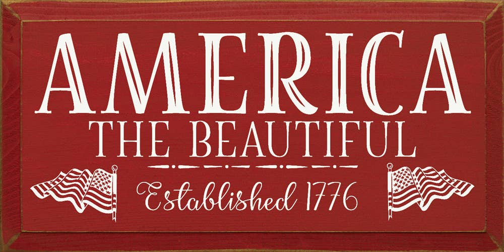 Decorative rectangular sign with “AMERICA THE BEAUTIFUL” text and striped flag icons