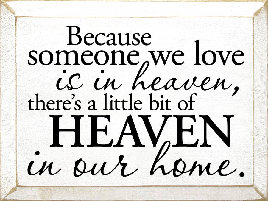 Wooden wall sign with quote: "...HEAVEN... in our home." in light wood frame.