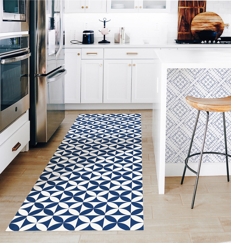 Peel-and-stick wallpaper with navy-and-white geometric medallion pattern on a light wall