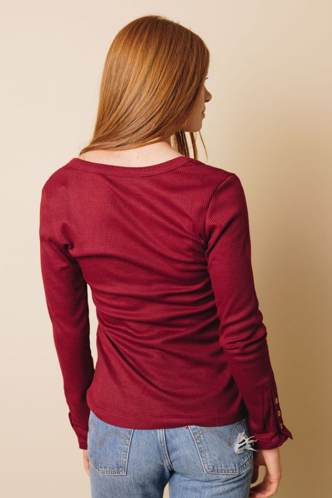 Burgundy long-sleeve button top, back view with buttoned sleeve cuffs