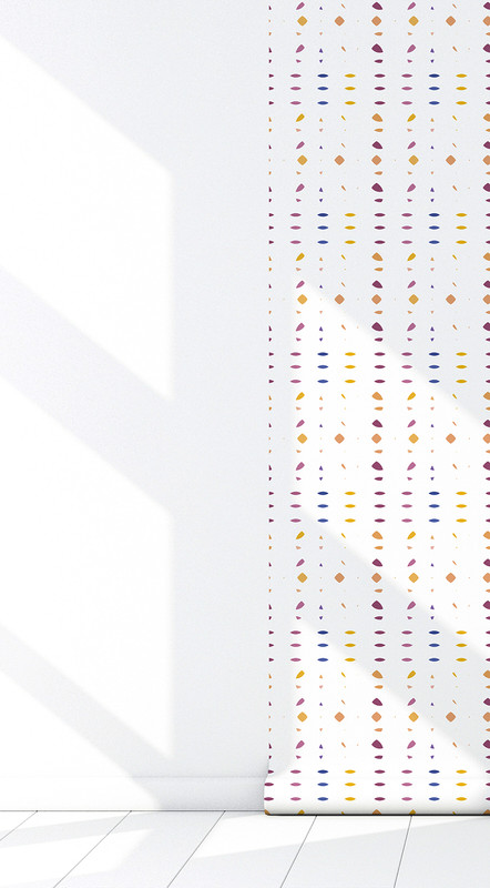 Multi-color polka-dot peel-and-stick wallpaper shown on a corner wall near the floor