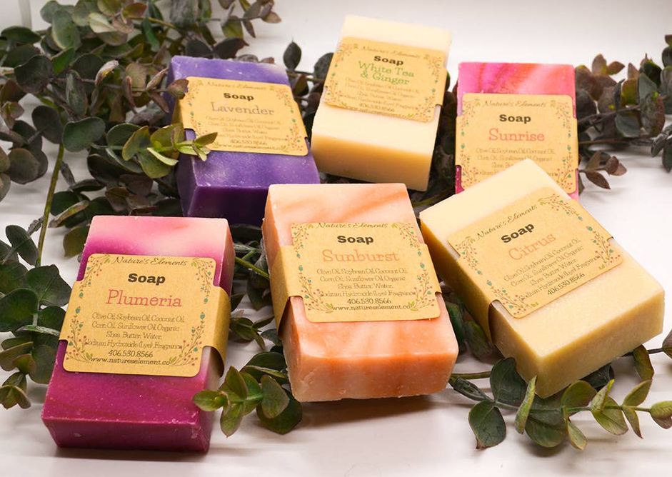 Handcrafted soap assortment: purple, orange, pink, and cream bars with labels