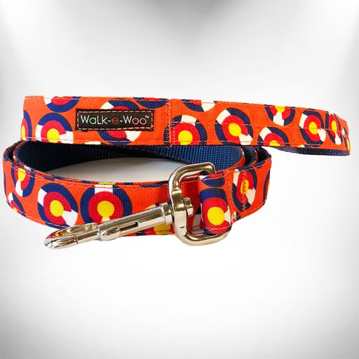 Orange patterned dog leash with metal clasp, D-ring, and Walk-e-Woo logo patch