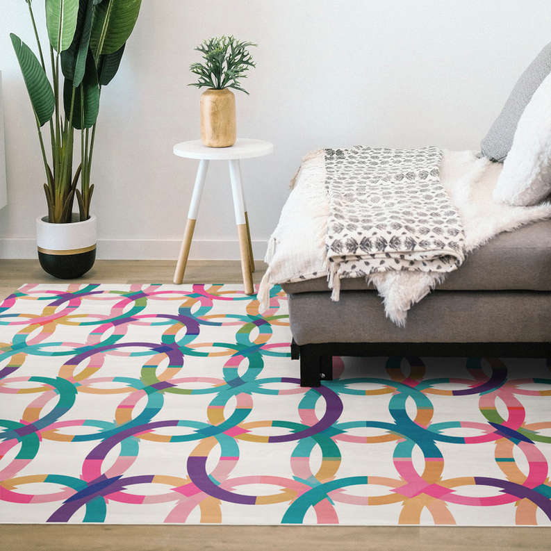 Multicolor geometric loop patterned indoor rug laid flat on the floor