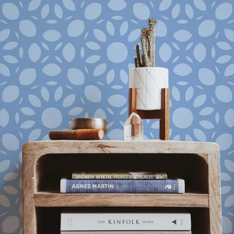 Peel-and-stick wallpaper with repeating light-blue leaf and oval floral pattern