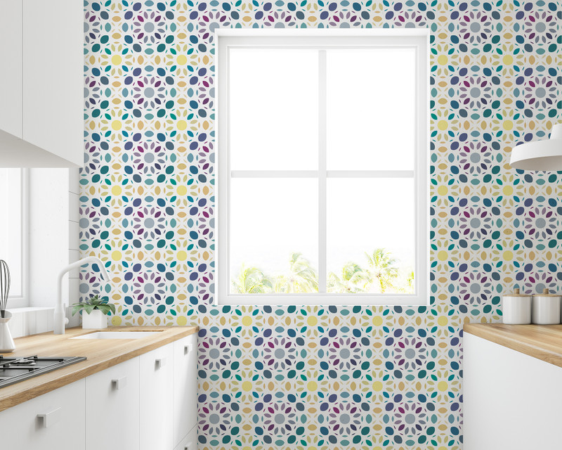 Peel-and-stick wallpaper with multi-color mosaic leaf pattern around a window.