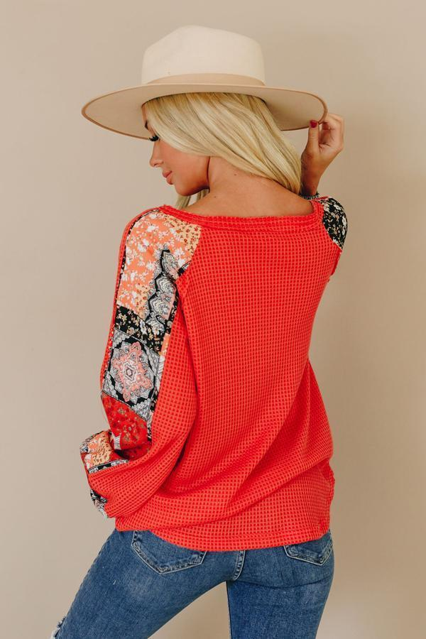 Red thermal top with waffle texture and floral paisley print sleeves, back view