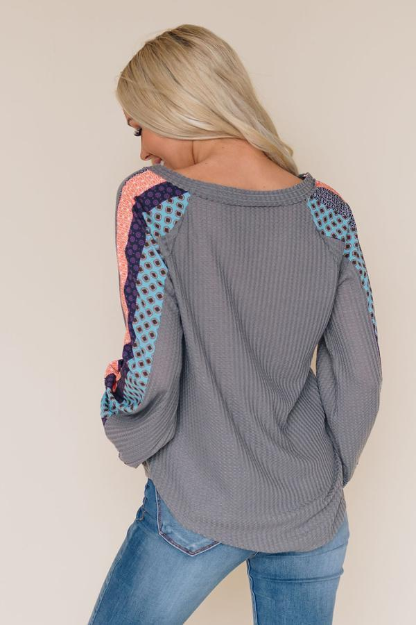Gray thermal top, back view: long sleeves with orange and blue patterned side panels