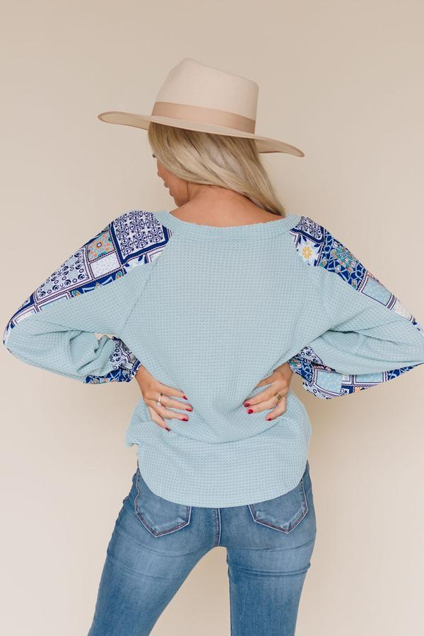 Light blue thermal top shown from back, patterned yoke and long sleeves