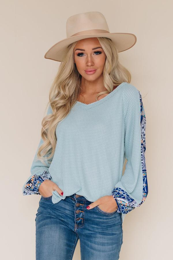 Light blue V-neck long-sleeve thermal top with patterned sleeve details