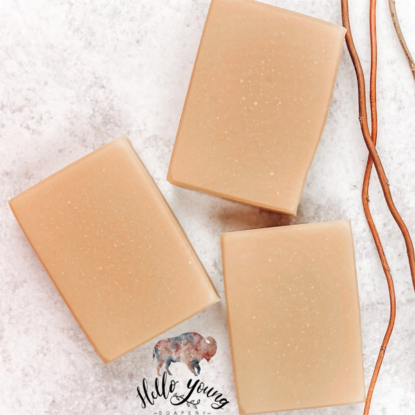 Goat milk soap bars, light tan with speckled texture, three rectangular pieces