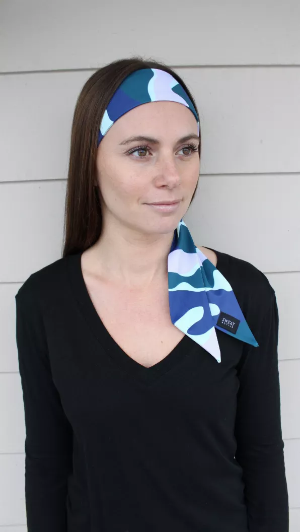 Sport headtie worn on model, blue and teal wave camo print with side bow