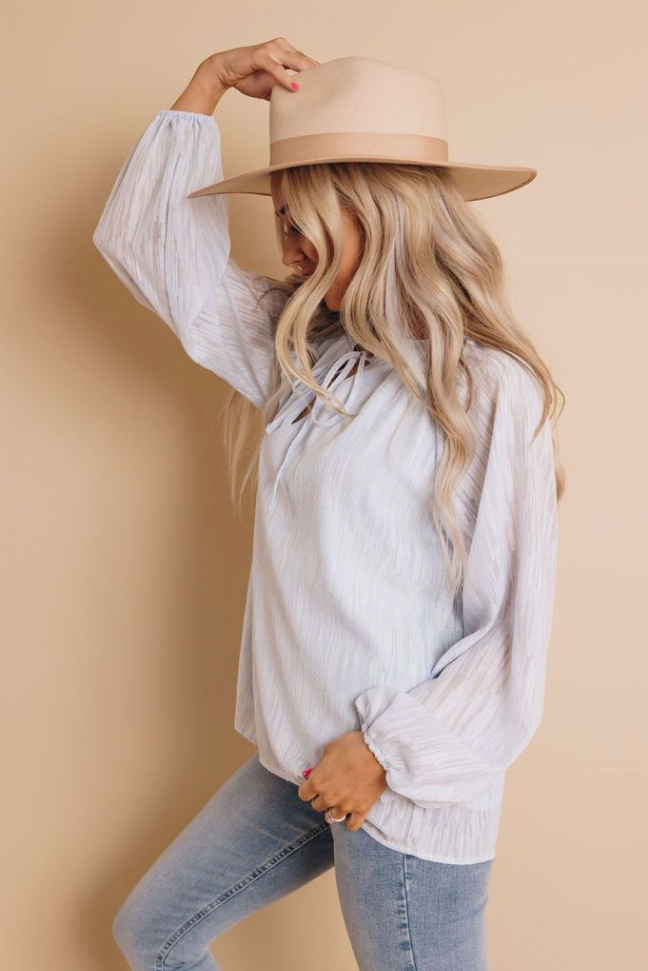 Off-white long-sleeve top with keyhole neckline and elastic cuffs