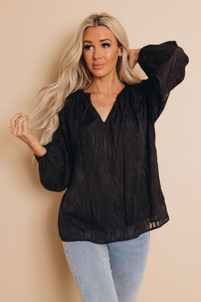Black V-neck long-sleeve top with gathered sleeves and sheer textured fabric