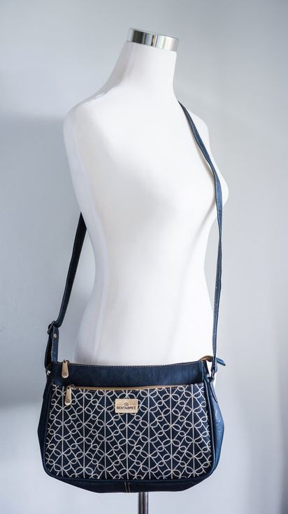 Navy patterned crossbody bag front view on mannequin with adjustable shoulder strap