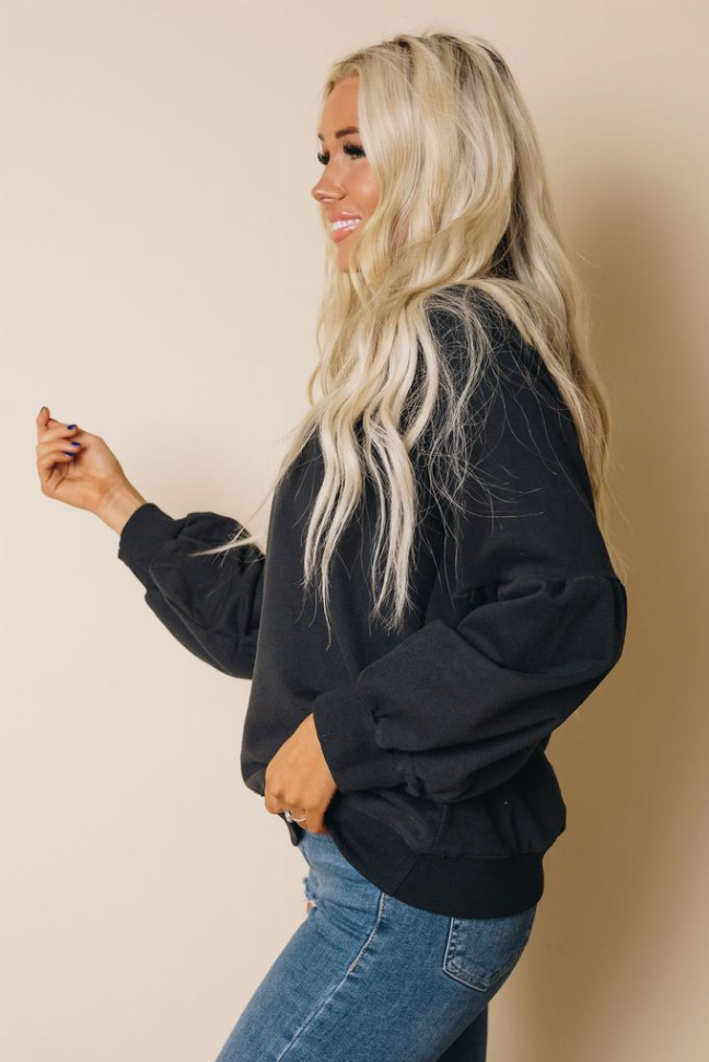 Balloon sleeve sweatshirt with crew neck and front pocket, dark charcoal, angled view.