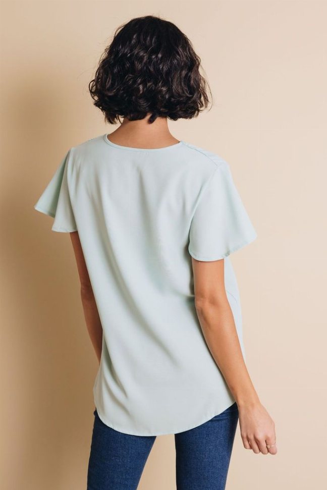 Light blue short-sleeve top, back view with relaxed fit and flared sleeves