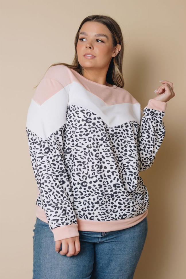 Pink and leopard-print color-block long-sleeve top with rounded neckline, front view.